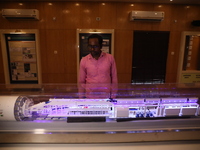 A worker looks at a model of a metro railway station at a construction site in Kolkata, India, on November 22, 2024. (