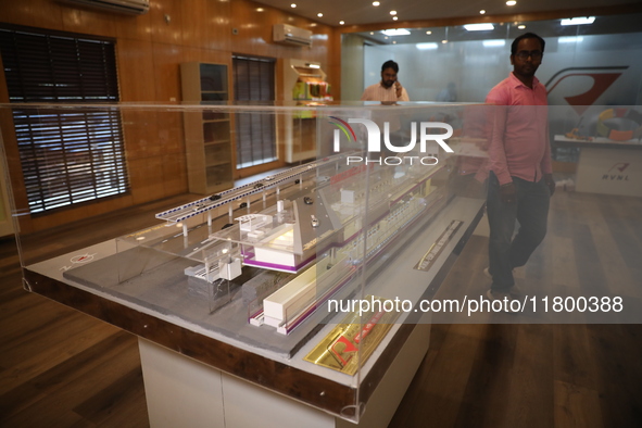 A worker looks at a model of a metro railway station at a construction site in Kolkata, India, on November 22, 2024. 