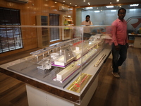 A worker looks at a model of a metro railway station at a construction site in Kolkata, India, on November 22, 2024. (