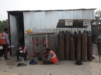 Labourers eat their food at a metro railway station construction site in Kolkata, India, on November 22, 2024. (