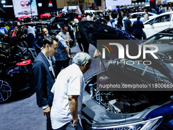 Visitors look at BYD's electric vehicles displayed during The Gaikindo Jakarta Auto Week in Tangerang, Indonesia, on November 22, 2024. The...