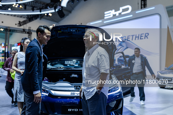 Visitors look at BYD's electric vehicles displayed during The Gaikindo Jakarta Auto Week in Tangerang, Indonesia, on November 22, 2024. The...