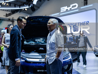 Visitors look at BYD's electric vehicles displayed during The Gaikindo Jakarta Auto Week in Tangerang, Indonesia, on November 22, 2024. The...