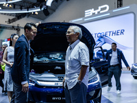 Visitors look at BYD's electric vehicles displayed during The Gaikindo Jakarta Auto Week in Tangerang, Indonesia, on November 22, 2024. The...