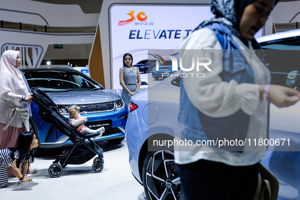 Visitors look at BYD's electric vehicles displayed during The Gaikindo Jakarta Auto Week in Tangerang, Indonesia, on November 22, 2024. The...