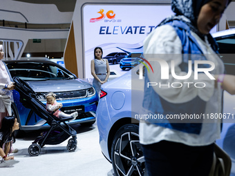 Visitors look at BYD's electric vehicles displayed during The Gaikindo Jakarta Auto Week in Tangerang, Indonesia, on November 22, 2024. The...