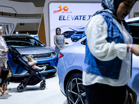 Visitors look at BYD's electric vehicles displayed during The Gaikindo Jakarta Auto Week in Tangerang, Indonesia, on November 22, 2024. The...