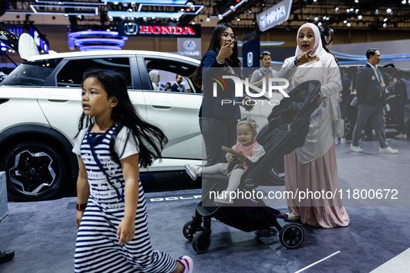 Visitors look at BYD's electric vehicles displayed during The Gaikindo Jakarta Auto Week in Tangerang, Indonesia, on November 22, 2024. The...