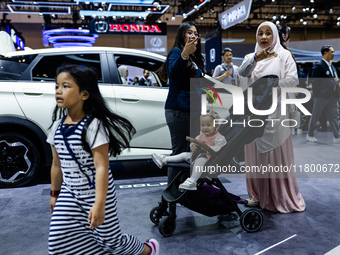 Visitors look at BYD's electric vehicles displayed during The Gaikindo Jakarta Auto Week in Tangerang, Indonesia, on November 22, 2024. The...