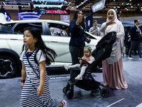 Visitors look at BYD's electric vehicles displayed during The Gaikindo Jakarta Auto Week in Tangerang, Indonesia, on November 22, 2024. The...