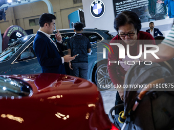 Visitors look at BMW's electric vehicles displayed during The Gaikindo Jakarta Auto Week in Tangerang, Indonesia, on November 22, 2024. The...