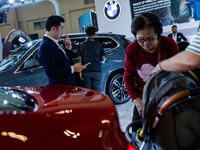 Visitors look at BMW's electric vehicles displayed during The Gaikindo Jakarta Auto Week in Tangerang, Indonesia, on November 22, 2024. The...