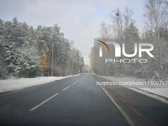 A tree lined road with snow is seen in Warsaw, Poland on 22 November, 2024. (