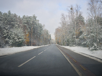 A tree lined road with snow is seen in Warsaw, Poland on 22 November, 2024. (