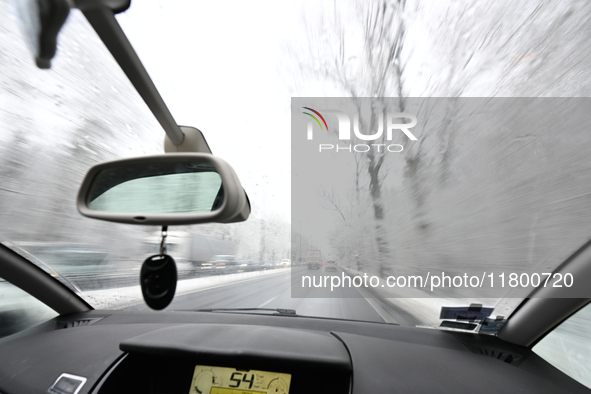 A tree lined road with snow is seen in Warsaw, Poland on 22 November, 2024. 