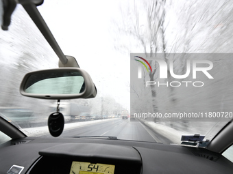 A tree lined road with snow is seen in Warsaw, Poland on 22 November, 2024. (