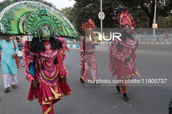 Indian tribal Chaw artists from Purulia walk on a street during the West Bengal Government-hosted ''Jangalmahal Utsav'' in Kolkata, India, o...