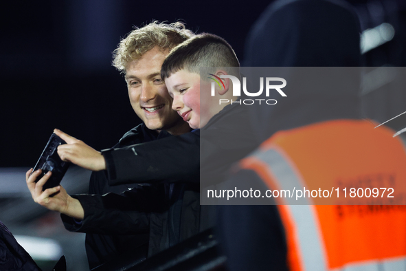 Cameron Hutchison of Newcastle Falcons takes a quick selfie with a fan before the Premiership Cup Group A match between Newcastle Falcons an...