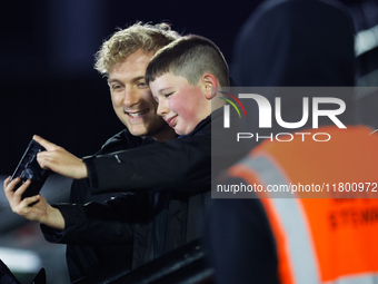 Cameron Hutchison of Newcastle Falcons takes a quick selfie with a fan before the Premiership Cup Group A match between Newcastle Falcons an...