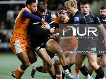 Ben Stevenson of Newcastle Falcons is in action as he is tackled by Obi Ene during the Premiership Cup Group A match between Newcastle Falco...