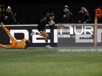 Ben Stevenson of Newcastle Falcons beats Tom Curtis of Sale Sharks to score in the corner during the Premiership Cup Group A match between N...