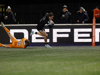 Ben Stevenson of Newcastle Falcons beats Tom Curtis of Sale Sharks to score in the corner during the Premiership Cup Group A match between N...