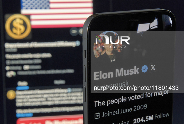 The photo shows Elon Musk’s personal X account displayed on an iPhone in the foreground, while the official X profile of the Department of G...