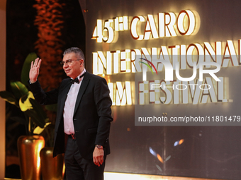 TV presenter Amr El Lathe stands on the red carpet at the conclusion of the Cairo Film Festival in its 45th session, held at the Egyptian Op...