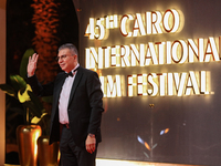 TV presenter Amr El Lathe stands on the red carpet at the conclusion of the Cairo Film Festival in its 45th session, held at the Egyptian Op...