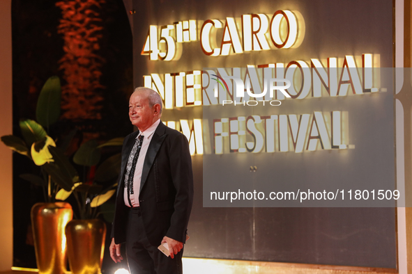 Businessman Naguib Sawiris stands on the red carpet at the conclusion of the Cairo Film Festival in its 45th session, held at the Egyptian O...