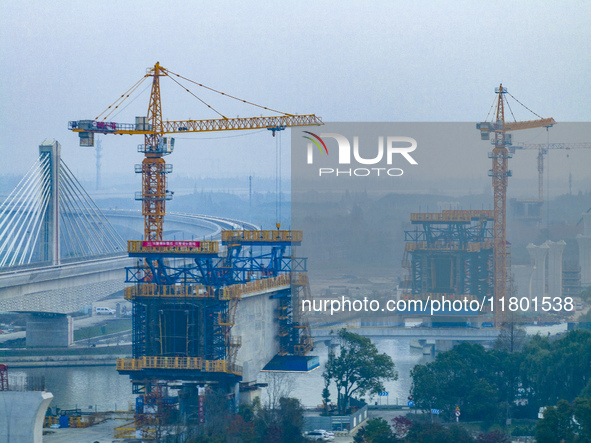 In Shanghai, China, on November 22, 2024, a photo shows the Shanghai Demonstration Zone Line crossing the Highway Port Bridge under construc...