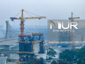 In Shanghai, China, on November 22, 2024, a photo shows the Shanghai Demonstration Zone Line crossing the Highway Port Bridge under construc...