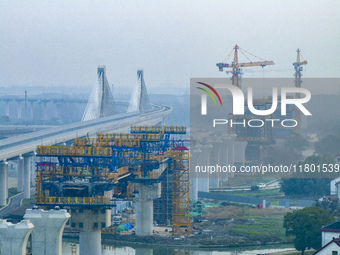 In Shanghai, China, on November 22, 2024, a photo shows the Shanghai Demonstration Zone Line crossing the Highway Port Bridge under construc...