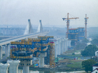 In Shanghai, China, on November 22, 2024, a photo shows the Shanghai Demonstration Zone Line crossing the Highway Port Bridge under construc...