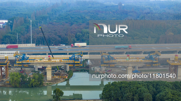 In Shanghai, China, on November 22, 2024, a photo shows the Shanghai Demonstration Zone Line crossing the Highway Port Bridge under construc...