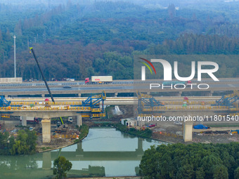 In Shanghai, China, on November 22, 2024, a photo shows the Shanghai Demonstration Zone Line crossing the Highway Port Bridge under construc...