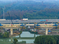 In Shanghai, China, on November 22, 2024, a photo shows the Shanghai Demonstration Zone Line crossing the Highway Port Bridge under construc...