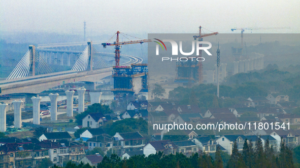 In Shanghai, China, on November 22, 2024, a photo shows the Shanghai Demonstration Zone Line crossing the Highway Port Bridge under construc...