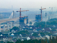 In Shanghai, China, on November 22, 2024, a photo shows the Shanghai Demonstration Zone Line crossing the Highway Port Bridge under construc...