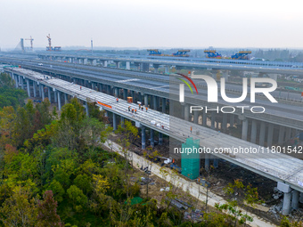 In Shanghai, China, on November 22, 2024, a photo shows the Shanghai Demonstration Zone Line crossing the Highway Port Bridge under construc...