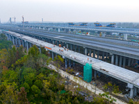 In Shanghai, China, on November 22, 2024, a photo shows the Shanghai Demonstration Zone Line crossing the Highway Port Bridge under construc...