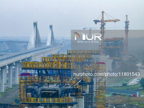 In Shanghai, China, on November 22, 2024, a photo shows the Shanghai Demonstration Zone Line crossing the Highway Port Bridge under construc...