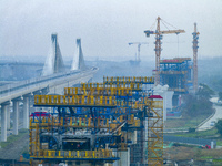 In Shanghai, China, on November 22, 2024, a photo shows the Shanghai Demonstration Zone Line crossing the Highway Port Bridge under construc...