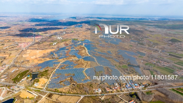 The photovoltaic power array area is on the barren hills on both sides of the rural road in Anqiu, China, on November 22, 2024. 