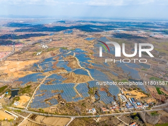 The photovoltaic power array area is on the barren hills on both sides of the rural road in Anqiu, China, on November 22, 2024. (