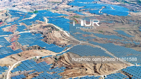 The photovoltaic power array area is on the barren hills on both sides of the rural road in Anqiu, China, on November 22, 2024. 