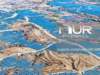 The photovoltaic power array area is on the barren hills on both sides of the rural road in Anqiu, China, on November 22, 2024. (