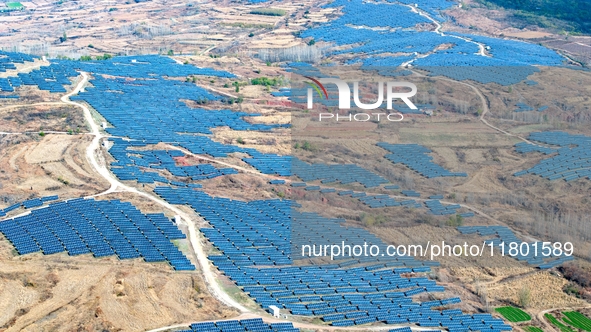 The photovoltaic power array area is on the barren hills on both sides of the rural road in Anqiu, China, on November 22, 2024. 