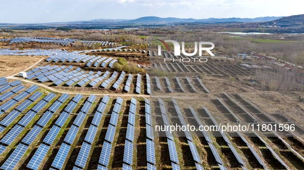 The photovoltaic power array area is on the barren hills on both sides of the rural road in Anqiu, China, on November 22, 2024. 