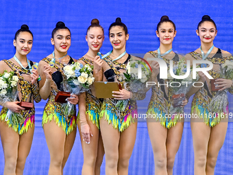 Gold medalists Team Uzbekistan celebrate on the podium after the Group Exercises 5 Hoops Final of the International Rhythmic Gymnastics Tour...